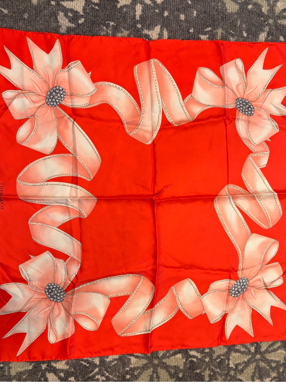 Tiffany & Co. silk square scarf featuring an elegant pink ribbon and bow motif